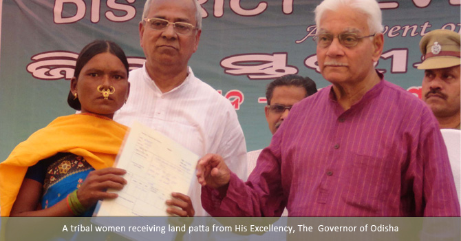 A tribal women receiving land patta from His Excellency, The  Governor of Odisha